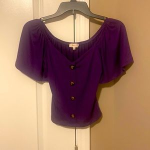 Cute purple top hits at the waist